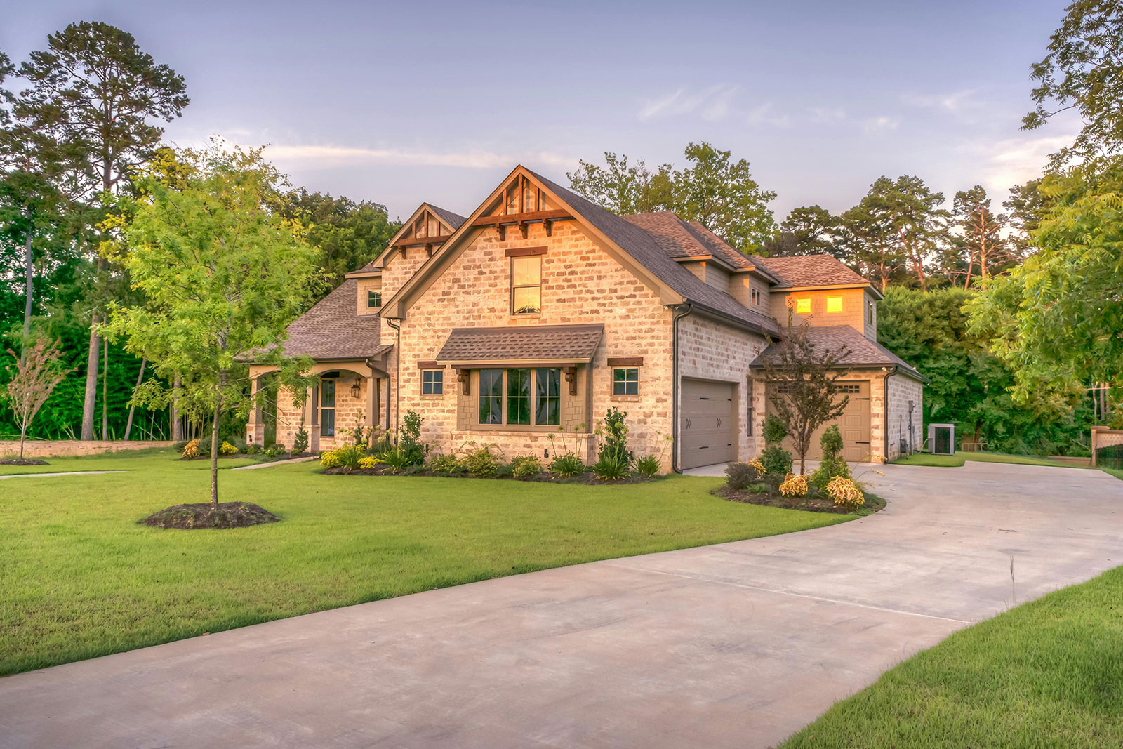 Suburban brick home with a manicured front lawn at dusk in Schaumburg, IL